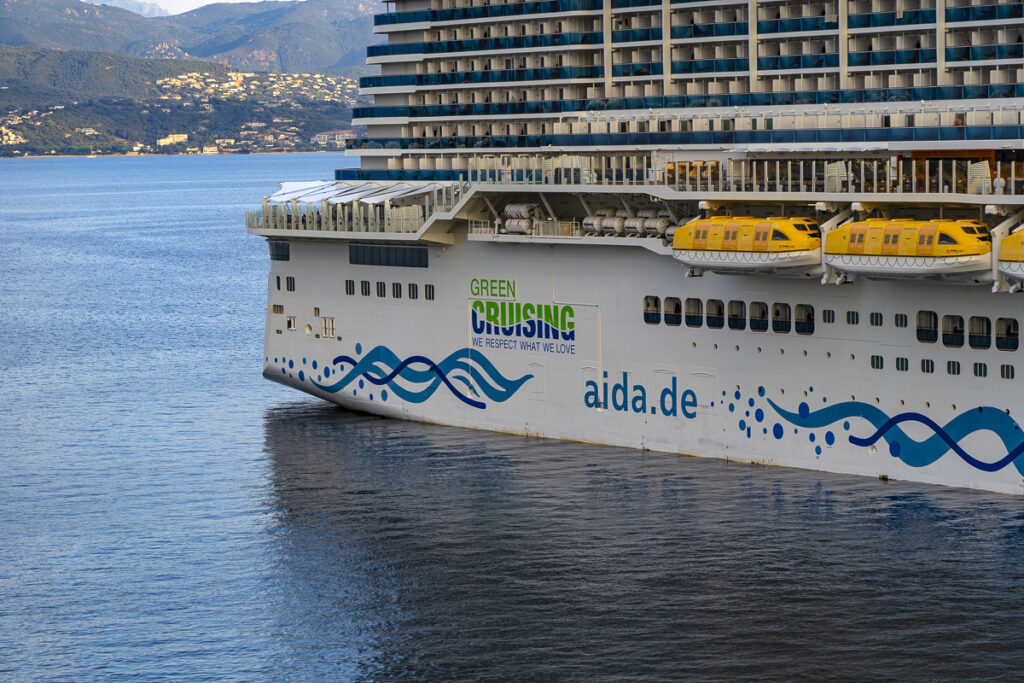 Aida Cosma cruise ship in port of Ajaccio, Corsica Aida Cosma cruise ship in port of Ajaccio, Corsica, which carries more than 6000 passengers, and some 1500 crew. By visiting Ajaccio, it can increase the city’s population by 10%, while having significant impacts on the places it visits, and the environment. Aida markets its cruise trips as “green cruising” because its ships are using liquified natural gas (LNG). However, LNG is not green - it is still a fossil fuel. According to the International Council on Clean Transportation, “LNG emits approximately 25% less carbon dioxide (CO2) than conventional marine fuels in providing the same amount of propulsion power. However, LNG is mostly methane, a potent greenhouse gas (GHG) that traps 86 times more heat in the atmosphere than the same amount of CO2 over a 20-year time period”. More broadly, according to Transport and Environment, Europe’s luxury cruise ships emit as much toxic sulphur as 1 billion cars. When the Italian city of Venice banned large cruise ships, air pollution dropped by 80%.